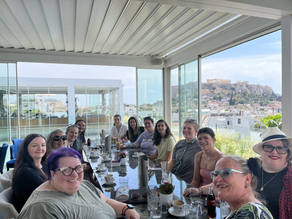 Around the table with several women in WordPress. The acropolis is in the background.