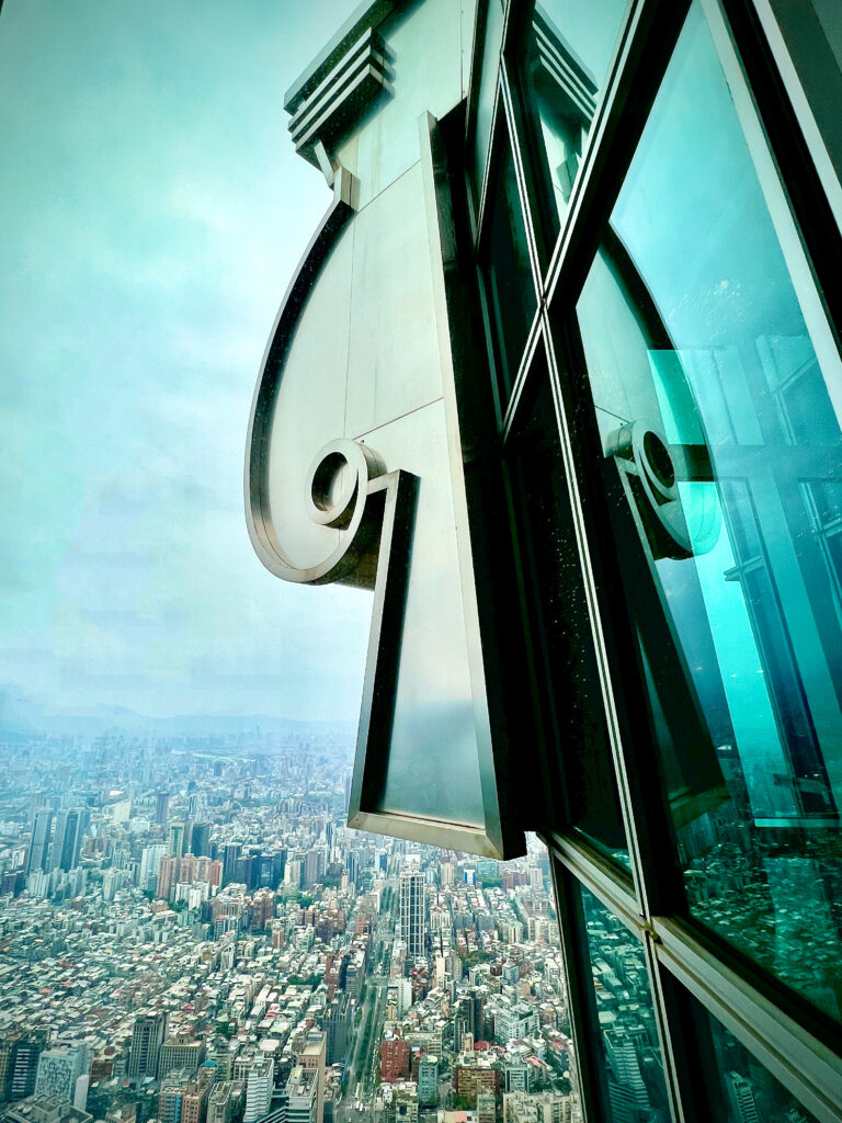 Looking out beyond the decorative embelishments on the observation level of Taipei 101