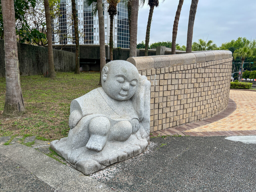 sculpture of a sleeping buddha in a park in Taipei