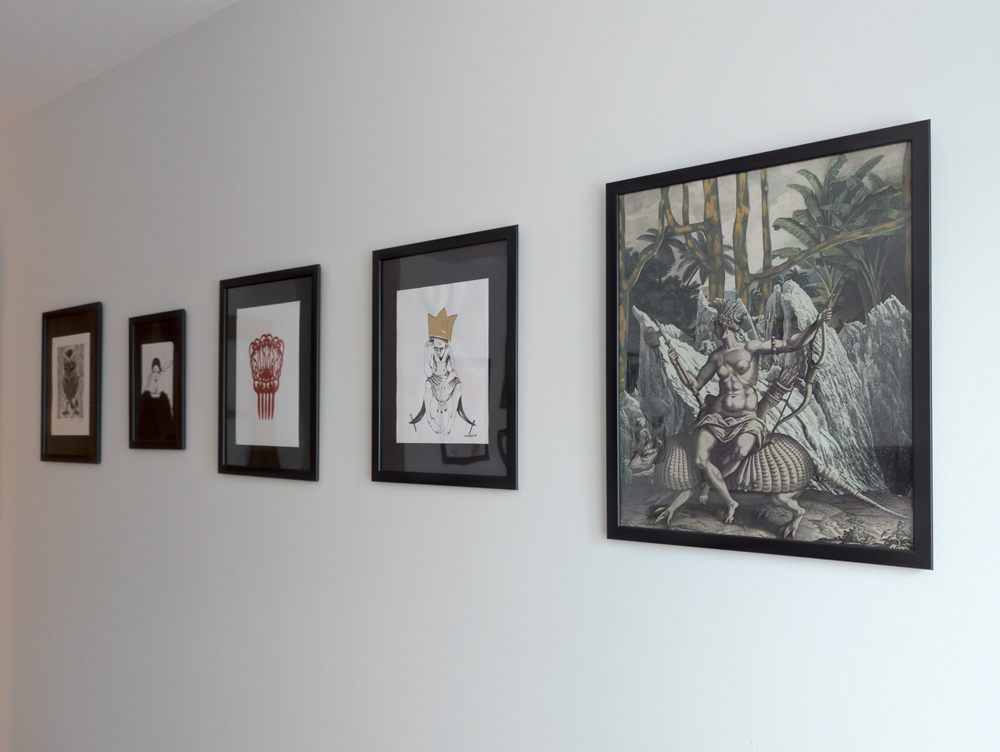 Gallery wall displaying five art pieces.