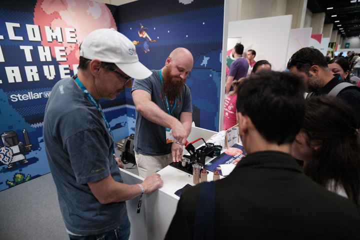 Attendees at the StellarWP booth at WCEU
