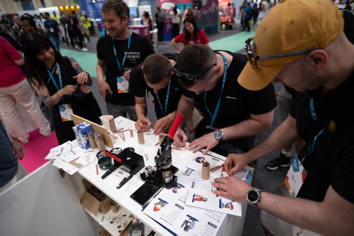 Attendees at the StellarWP booth at WCEU