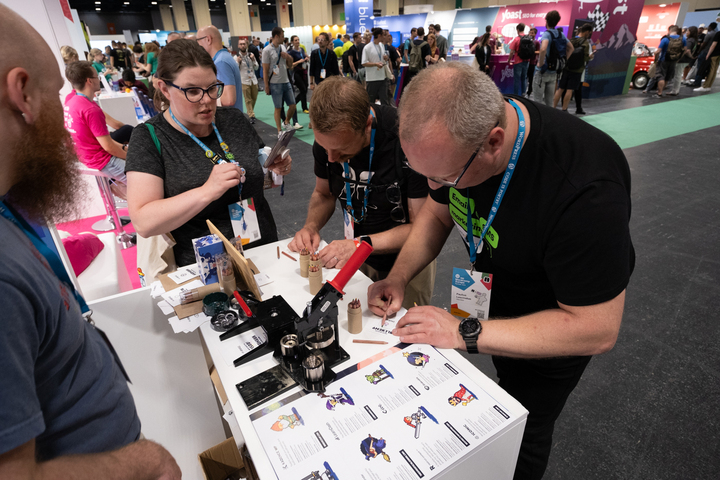 Attendees at the StellarWP booth at WCEU